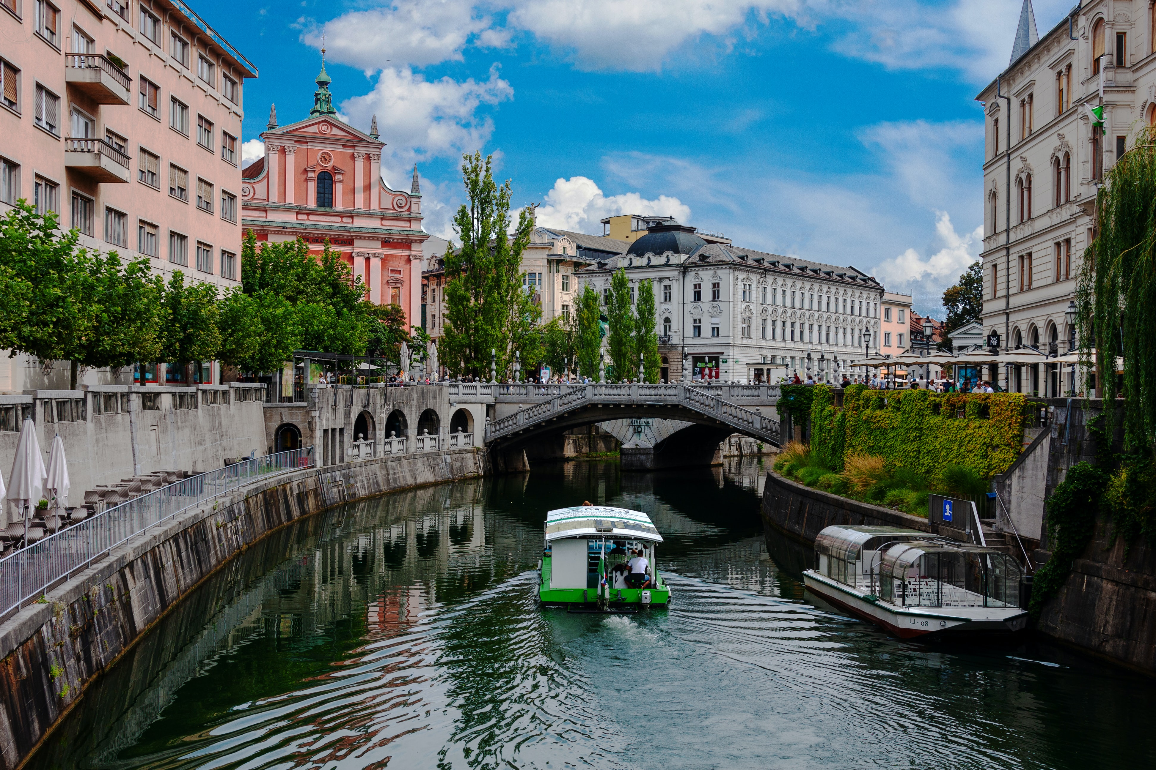 Ljubljana river with boat passing through