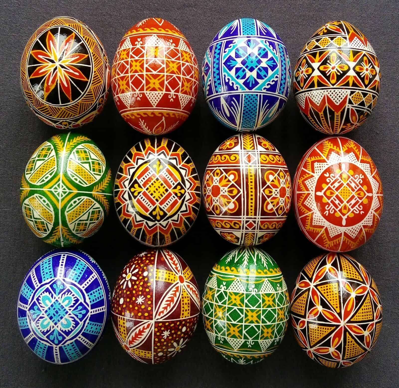 Twelve Ukrainian pysanky (decorated eggs) in a variety of colors and designs.